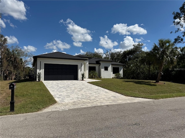 view of front of home with a front lawn and a garage