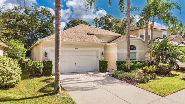 mediterranean / spanish house with a front yard and a garage