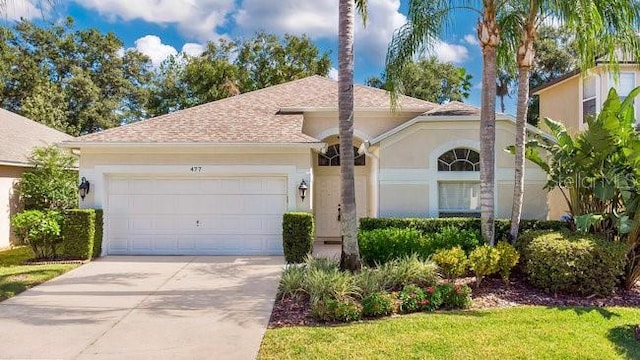 mediterranean / spanish-style home with a garage