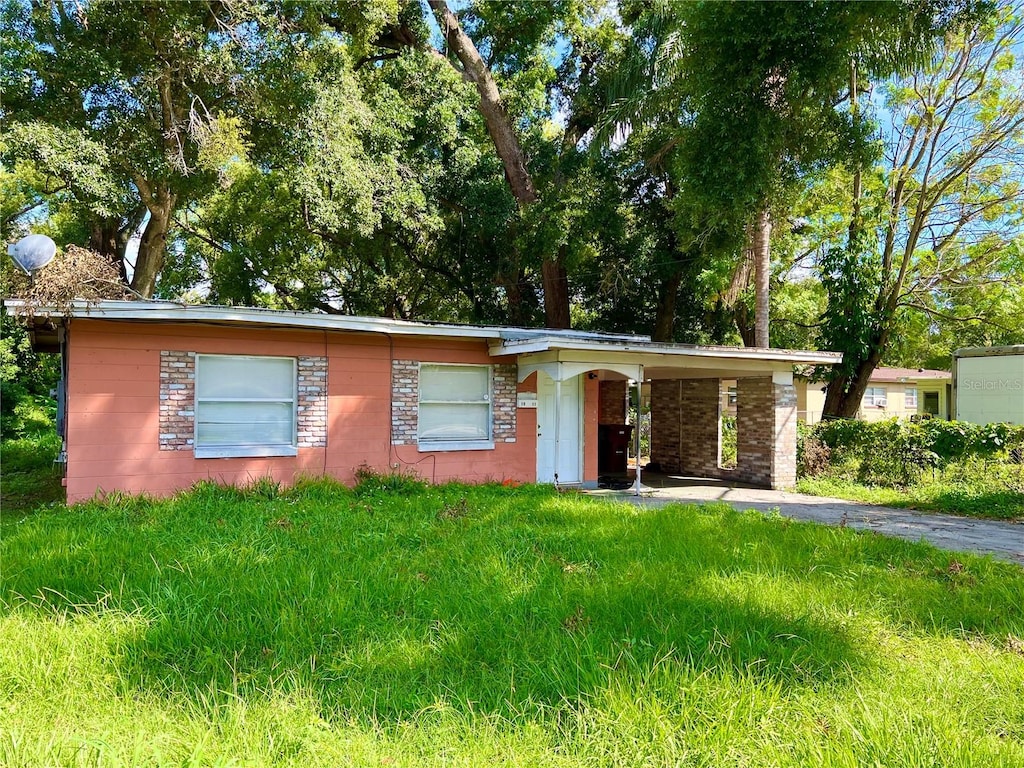 ranch-style house featuring a carport