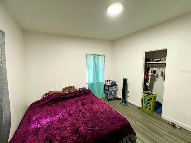 bedroom with wood-type flooring and a closet