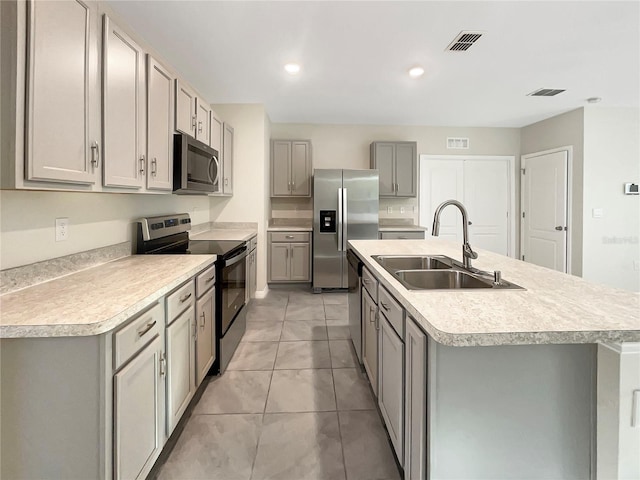 309 Gina Ln, Davenport, FL 33837 - kitchen with stainless steel appliances, a sink, gray cabinets, and recessed lighting