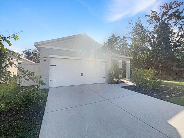 309 Gina Ln, Davenport, FL 33837 - view of side of property with driveway and a garage