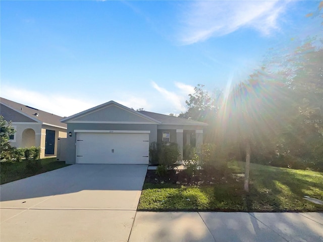 309 Gina Ln, Davenport, FL 33837 - single story home featuring concrete driveway, a garage, and stucco siding