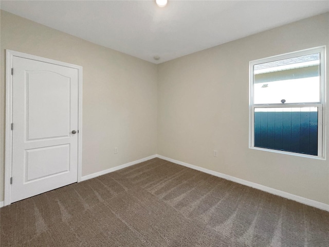 309 Gina Ln, Davenport, FL 33837 - unfurnished room featuring carpet flooring and baseboards