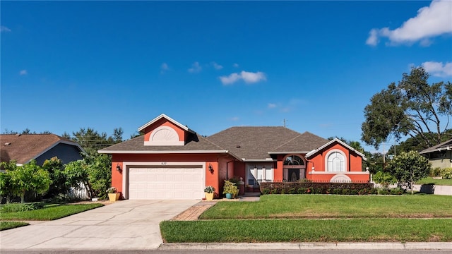 view of front of house with a front yard and a garage