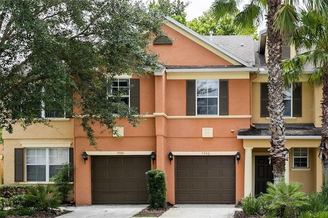 townhome / multi-family property featuring a garage