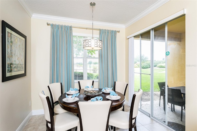 tiled dining area featuring ornamental molding and a textured ceiling