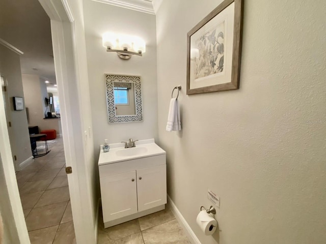 bathroom with vanity, crown molding, and tile patterned flooring