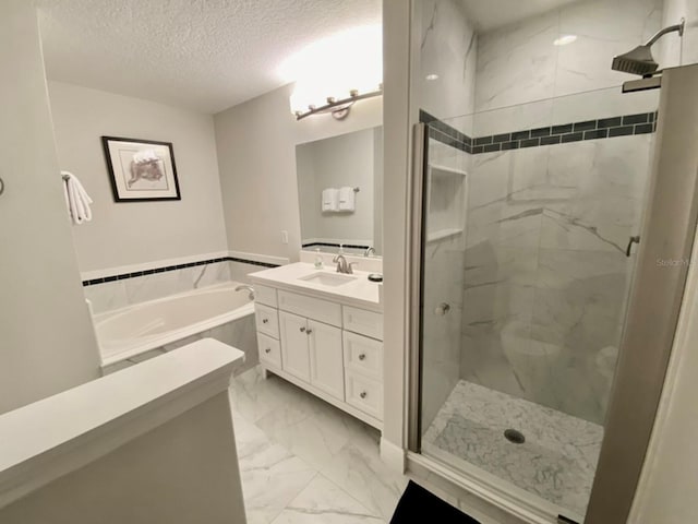 bathroom with vanity, a textured ceiling, and independent shower and bath