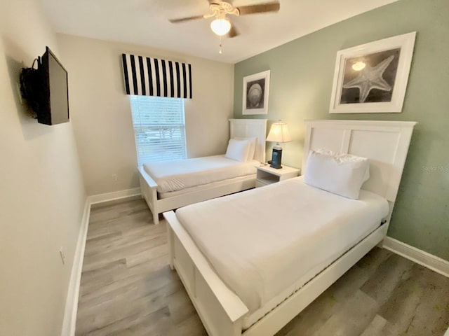 bedroom with light wood-type flooring and ceiling fan