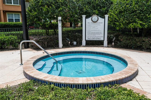 view of swimming pool with a community hot tub