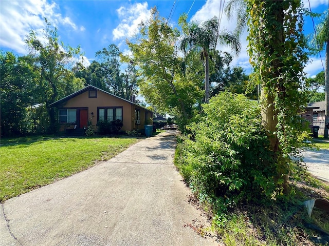 view of side of home with a yard