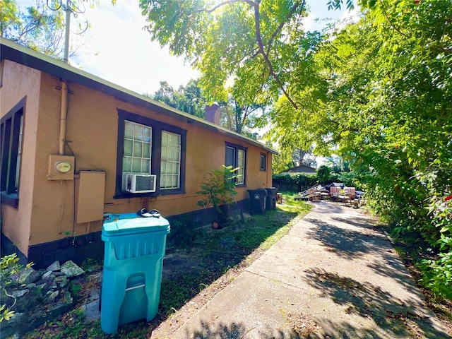 view of side of home featuring cooling unit