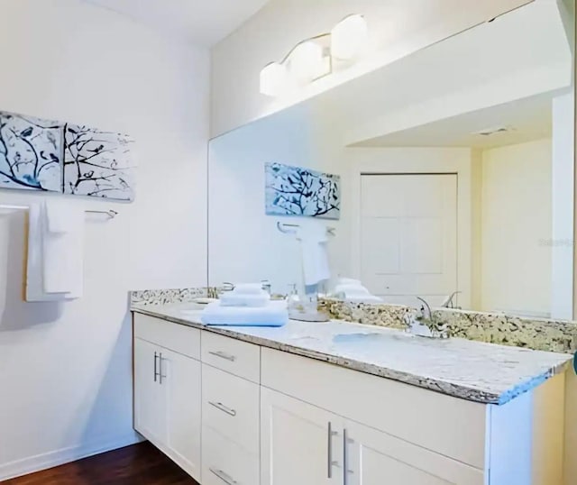 bathroom with vanity and hardwood / wood-style flooring