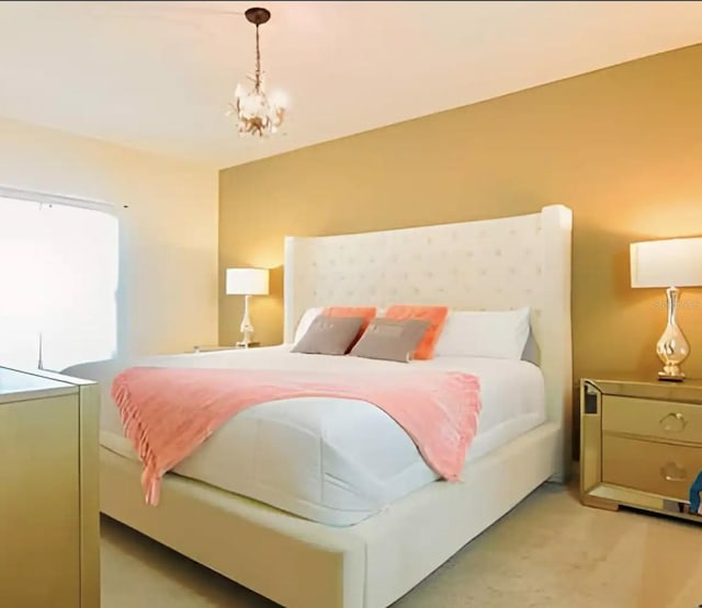 carpeted bedroom with a notable chandelier