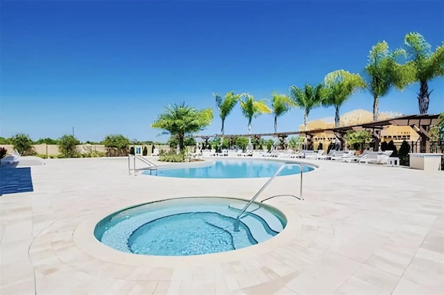 view of pool featuring a community hot tub and a patio area