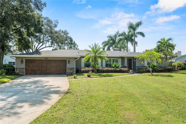 ranch-style home featuring a front lawn and a garage