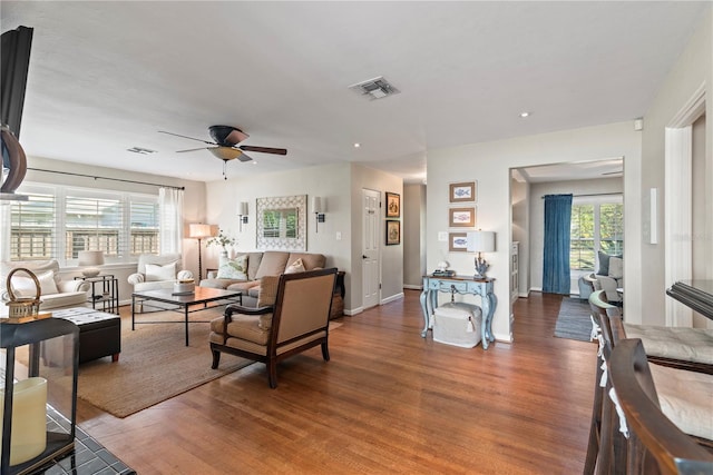 living room with ceiling fan and wood-type flooring