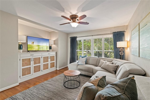 living room with ceiling fan and wood-type flooring