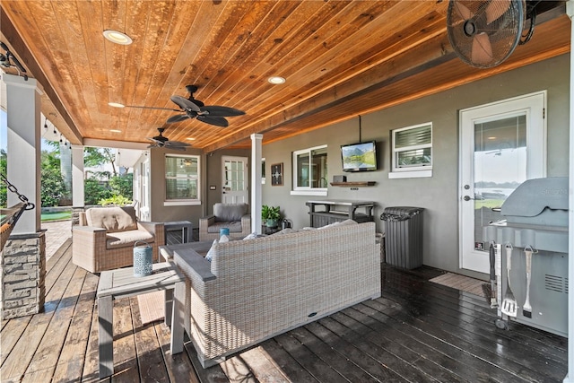 wooden terrace with outdoor lounge area and ceiling fan