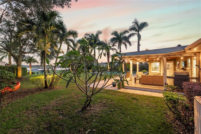 yard at dusk with an outdoor hangout area and a patio area