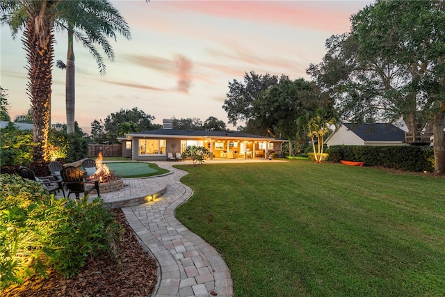 yard at dusk featuring a patio