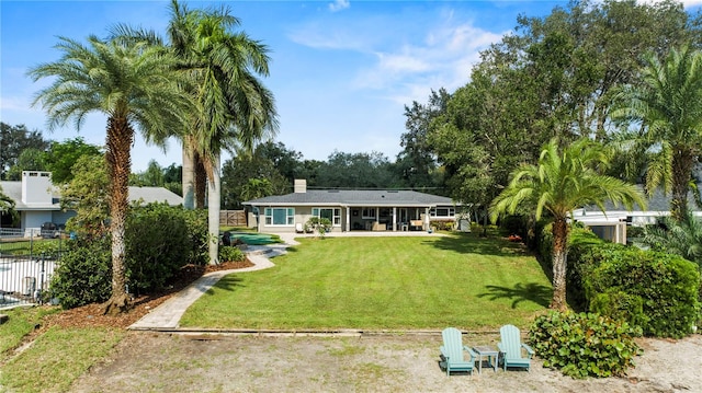 back of property featuring a lawn