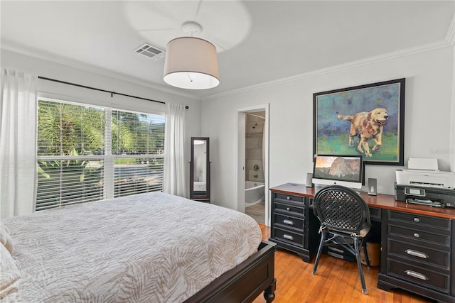 bedroom featuring connected bathroom, light hardwood / wood-style floors, and ornamental molding