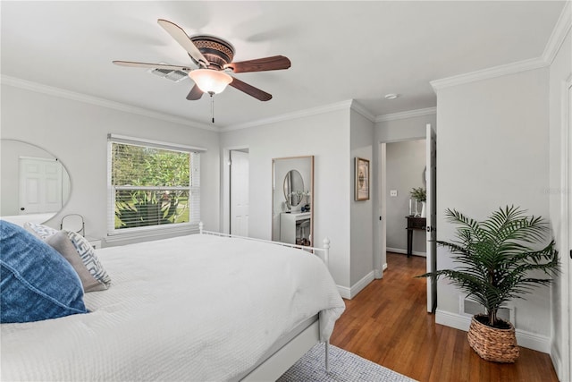 bedroom featuring ornamental molding, hardwood / wood-style floors, and ceiling fan