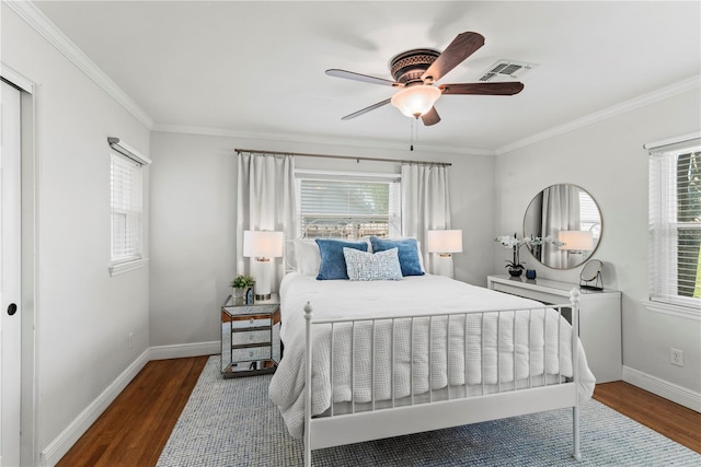 bedroom with crown molding, multiple windows, dark hardwood / wood-style floors, and ceiling fan