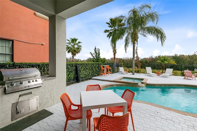 view of swimming pool with a patio, an in ground hot tub, and a grill