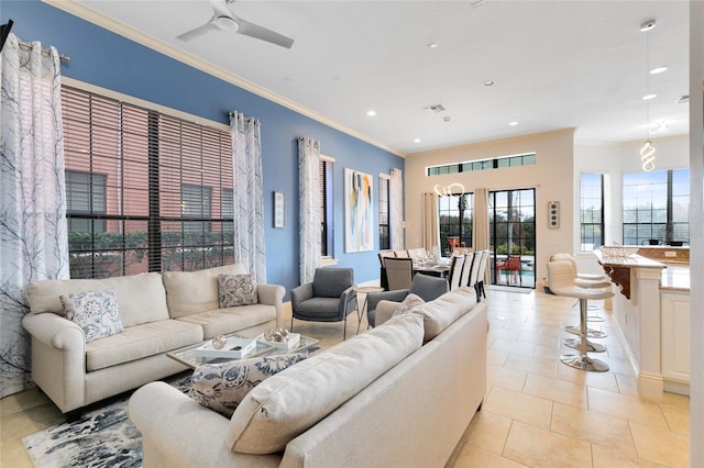 living room featuring ceiling fan, ornamental molding, and light tile patterned floors