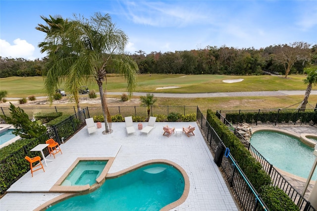 view of swimming pool featuring a patio area and an in ground hot tub