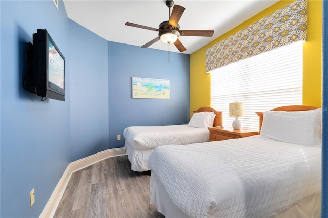 bedroom with hardwood / wood-style floors and ceiling fan