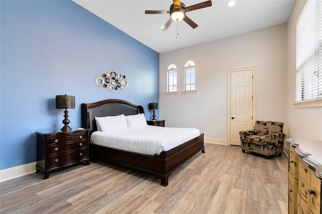 bedroom featuring light hardwood / wood-style flooring, multiple windows, and ceiling fan