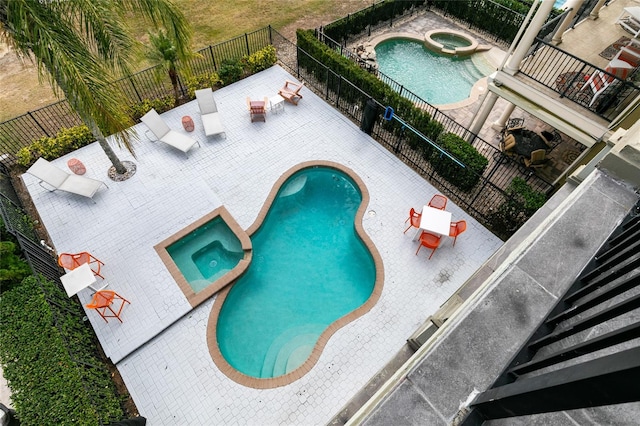 view of pool featuring an in ground hot tub and a patio area