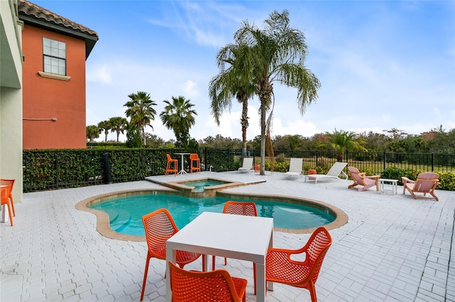 view of pool with an in ground hot tub and a patio area