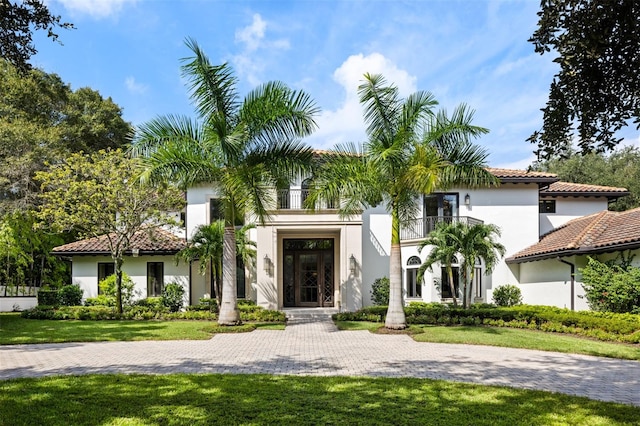 mediterranean / spanish-style home featuring a front yard