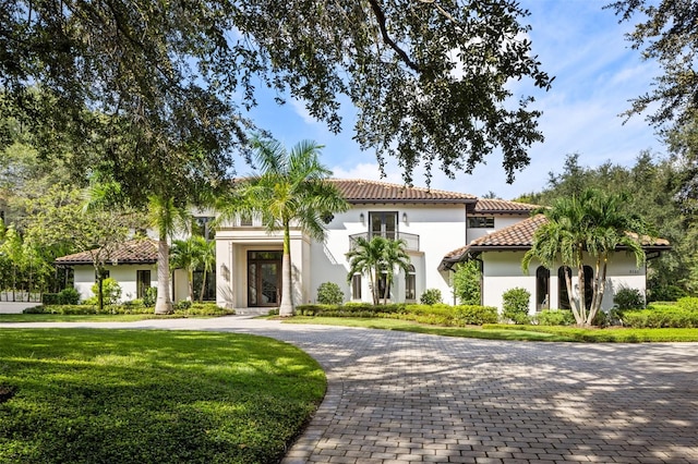 mediterranean / spanish home featuring a front yard