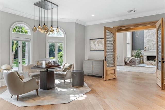 dining area featuring crown molding, a chandelier, and light wood-type flooring