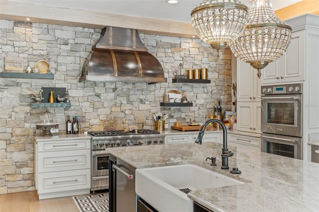 kitchen with light hardwood / wood-style flooring, sink, custom exhaust hood, appliances with stainless steel finishes, and light stone counters