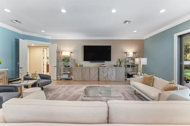 living room featuring light hardwood / wood-style floors and crown molding