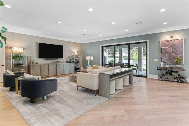 living room with light hardwood / wood-style flooring and ornamental molding