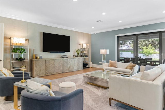 living room featuring light hardwood / wood-style floors, french doors, and ornamental molding