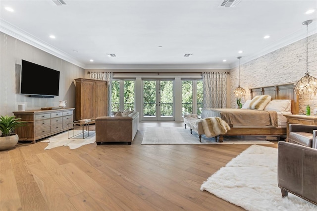 bedroom with crown molding, light hardwood / wood-style flooring, and a chandelier