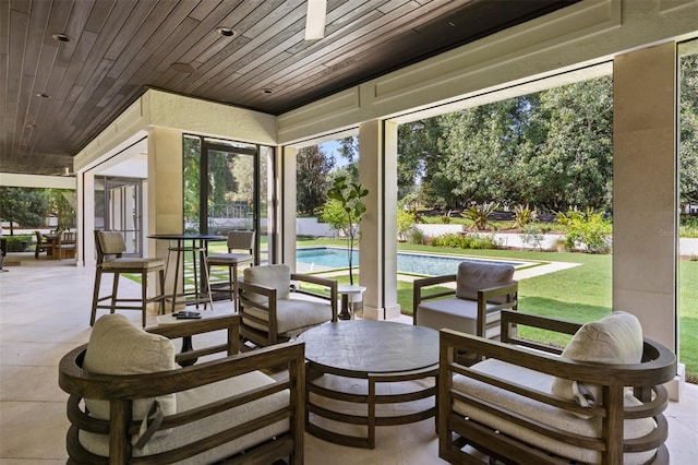 sunroom / solarium featuring wooden ceiling