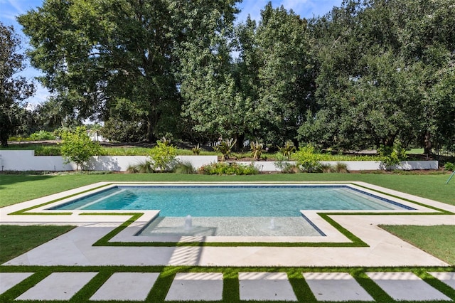 view of pool with a patio area and a lawn