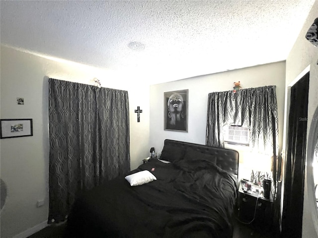 bedroom with cooling unit and a textured ceiling