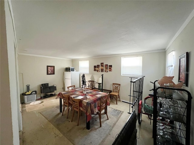 dining space with ornamental molding